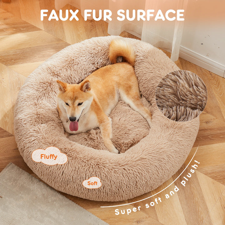 Shiba Inu resting in the tan coral fleece donut Calming Nest bed, 'super soft and plush' callouts